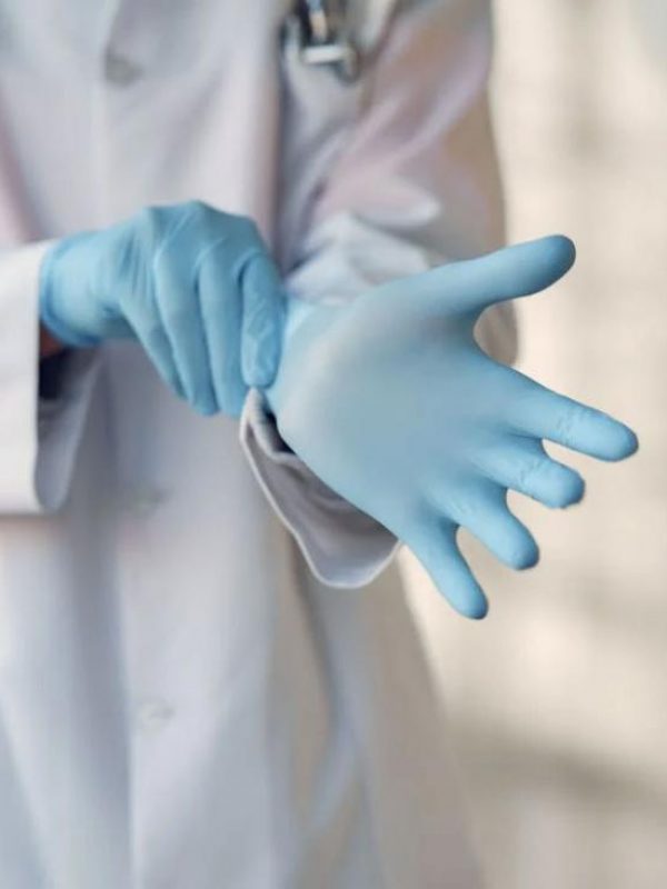 a-doctor-in-a-white-coat-putting-on-gloves-to-perform-a-pap-smear-test-in-a-clinic-1722498643